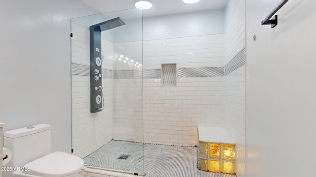 bathroom with toilet and tiled shower