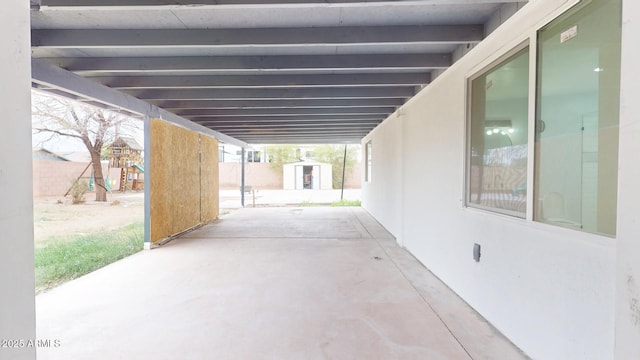 view of patio / terrace with a playground and a shed