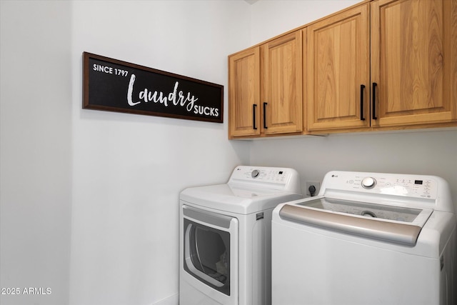 laundry room with cabinet space and washing machine and clothes dryer