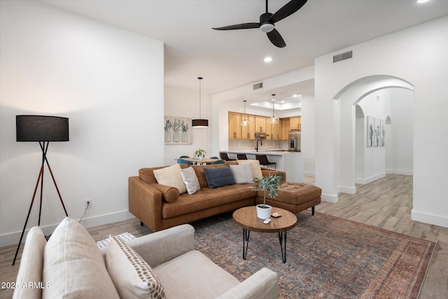 living area with baseboards, recessed lighting, light wood-style floors, visible vents, and ceiling fan