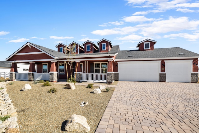 craftsman house featuring covered porch and a garage