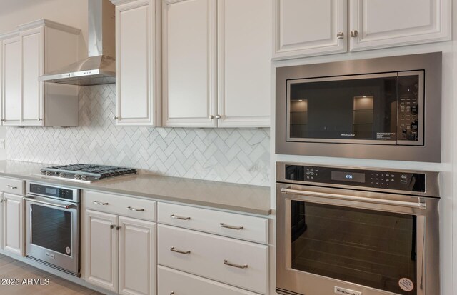 26696 W Siesta Ln, Buckeye, AZ 85396 - kitchen featuring decorative backsplash, light countertops, wall chimney exhaust hood, and appliances with stainless steel finishes