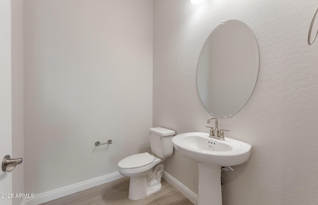 26696 W Siesta Ln, Buckeye, AZ 85396 - bathroom featuring baseboards, wood finished floors, and toilet