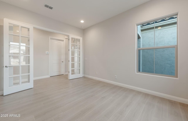 26696 W Siesta Ln, Buckeye, AZ 85396 - empty room featuring baseboards, visible vents, french doors, and light wood-style floors