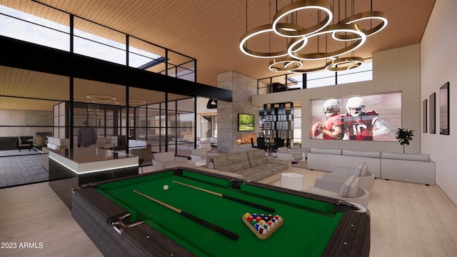 game room featuring a towering ceiling, wooden ceiling, pool table, light hardwood / wood-style flooring, and plenty of natural light