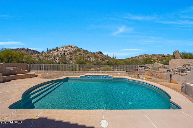 view of pool with a patio, a mountain view, fence, and a fenced in pool