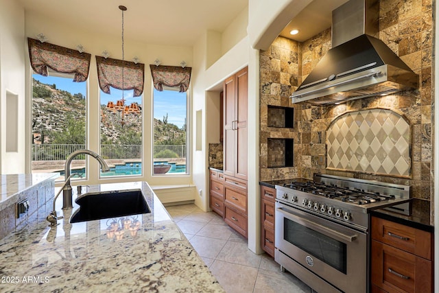 kitchen featuring stainless steel range, plenty of natural light, a sink, and extractor fan