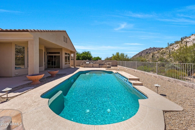 view of swimming pool with a fenced backyard, a fenced in pool, a patio area, outdoor lounge area, and a mountain view