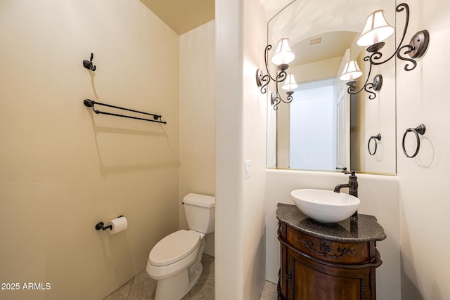 bathroom featuring vanity, toilet, and visible vents
