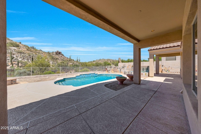 view of swimming pool with a fenced backyard, a patio area, a mountain view, and a fenced in pool
