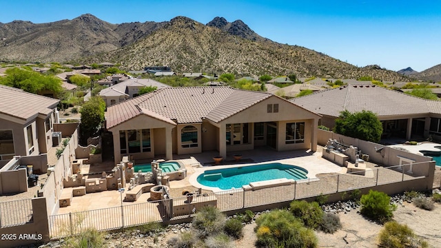 view of pool with an in ground hot tub, a fenced in pool, a fenced backyard, and a patio area