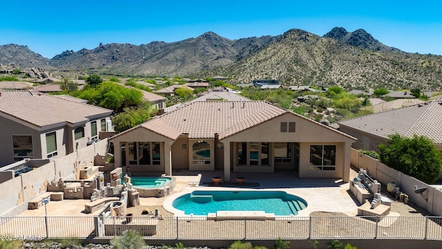 view of swimming pool with a fenced in pool, a patio area, a mountain view, an outdoor hot tub, and a fenced backyard
