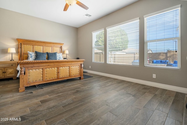 bedroom with visible vents, dark wood finished floors, baseboards, and ceiling fan