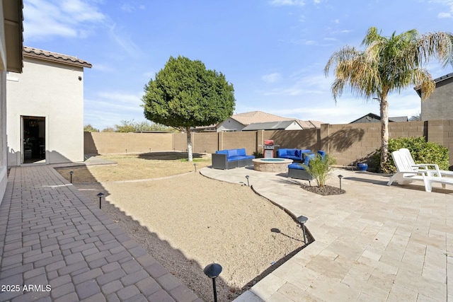 view of patio featuring an outdoor fire pit and a fenced backyard