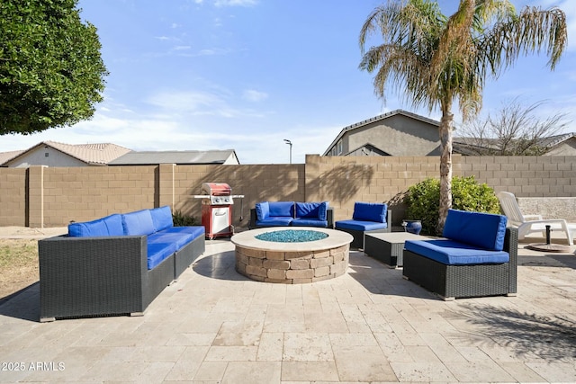 view of patio featuring a fenced backyard, area for grilling, and an outdoor living space with a fire pit