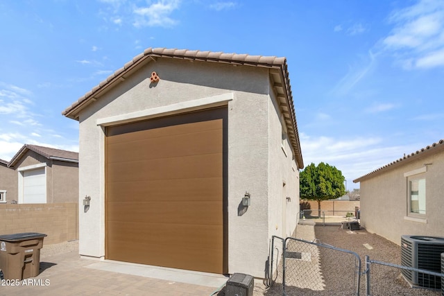 garage featuring cooling unit and fence