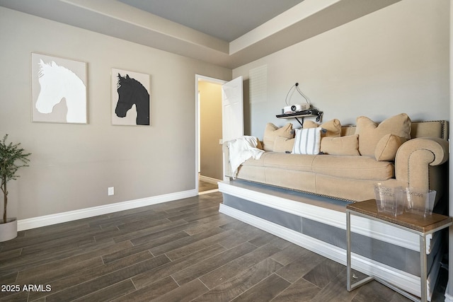 bedroom with dark wood-style flooring and baseboards