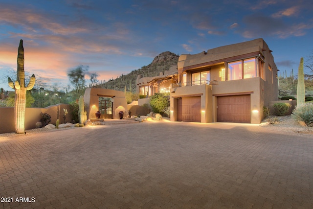 pueblo revival-style home with a garage