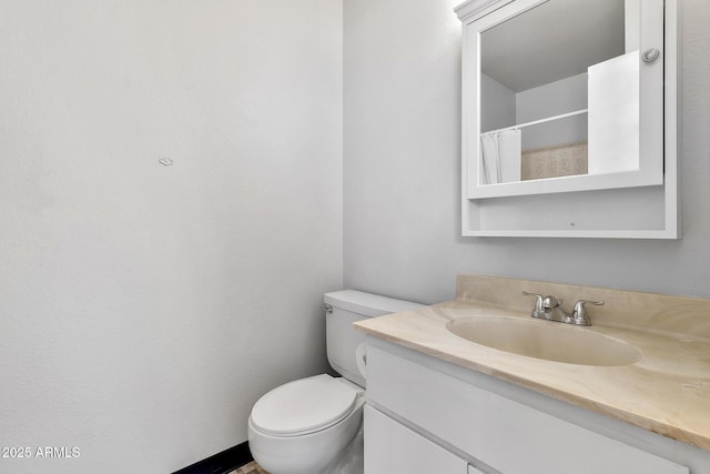 bathroom with vanity, curtained shower, and toilet