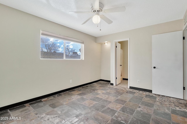 spare room with ceiling fan and a textured ceiling