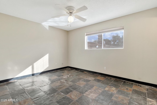 empty room featuring a textured ceiling and ceiling fan