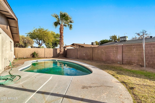 view of swimming pool with cooling unit and a patio area