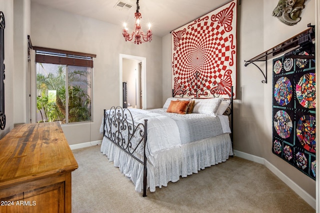 bedroom with light carpet and a chandelier