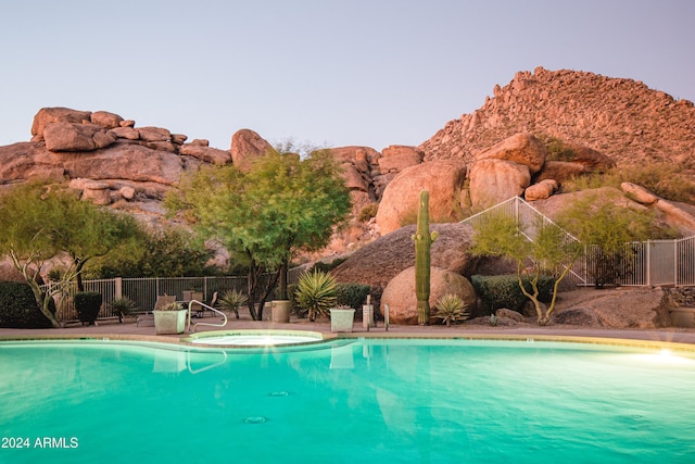 view of swimming pool featuring an in ground hot tub