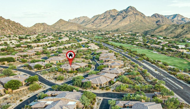 birds eye view of property with a mountain view