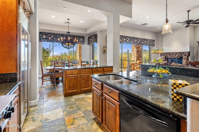 kitchen featuring dishwasher, a wealth of natural light, ceiling fan, and dark stone counters