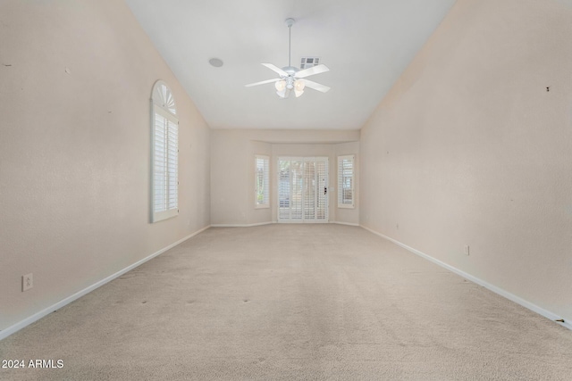 carpeted spare room with ceiling fan