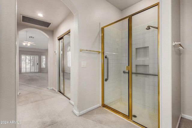 bathroom featuring walk in shower and ceiling fan