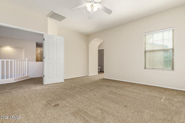 carpeted spare room with ceiling fan