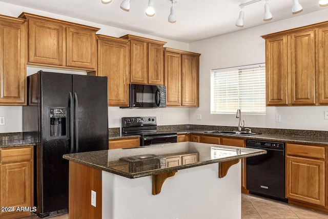 kitchen with sink, rail lighting, a kitchen island, and black appliances