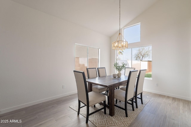 3837 E Windsong Dr, Phoenix, AZ 85048 - dining room with a chandelier, high vaulted ceiling, healthy amount of natural light, wood finished floors, and baseboards