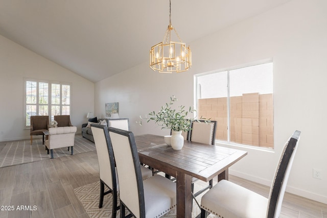 3837 E Windsong Dr, Phoenix, AZ 85048 - dining room featuring a chandelier, light wood-style floors, baseboards, and high vaulted ceiling