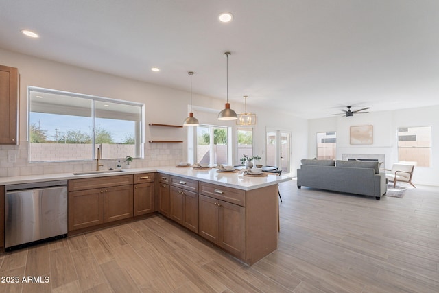 3837 E Windsong Dr, Phoenix, AZ 85048 - kitchen featuring dishwasher, a sink, tasteful backsplash, a peninsula, and light countertops