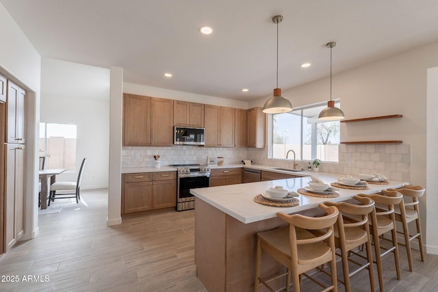 3837 E Windsong Dr, Phoenix, AZ 85048 - kitchen featuring stainless steel appliances, light countertops, open shelves, a peninsula, and tasteful backsplash