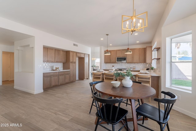 3837 E Windsong Dr, Phoenix, AZ 85048 - dining space with a chandelier, baseboards, light wood-style floors, and recessed lighting