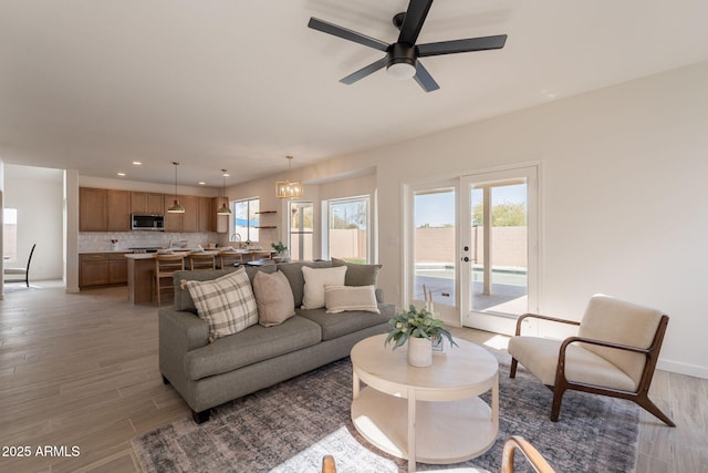 3837 E Windsong Dr, Phoenix, AZ 85048 - living area featuring ceiling fan, light wood-style floors, recessed lighting, and baseboards