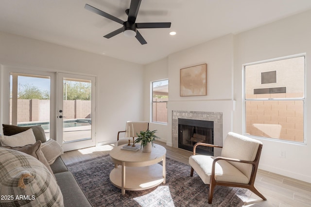 3837 E Windsong Dr, Phoenix, AZ 85048 - living area with plenty of natural light, ceiling fan, a tile fireplace, light wood finished floors, and recessed lighting