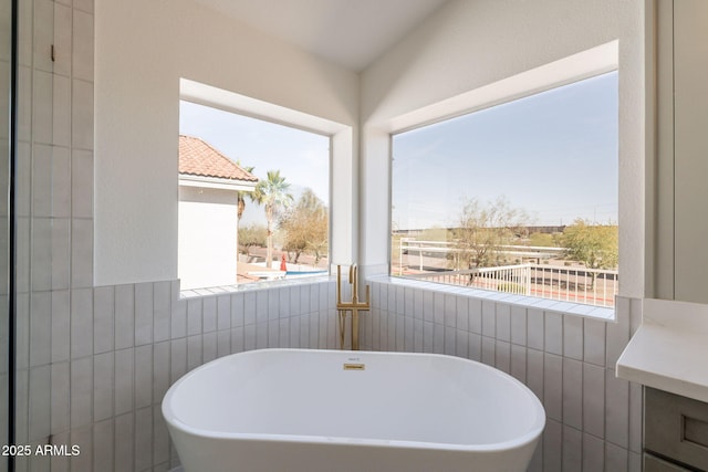 3837 E Windsong Dr, Phoenix, AZ 85048 - full bathroom featuring a freestanding tub, vanity, and tile walls