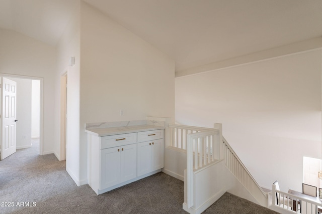 3837 E Windsong Dr, Phoenix, AZ 85048 - corridor with carpet flooring, vaulted ceiling, baseboards, and an upstairs landing