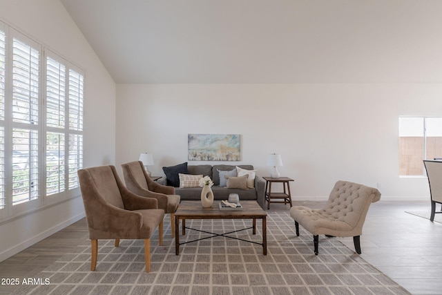 3837 E Windsong Dr, Phoenix, AZ 85048 - living area featuring light wood-style floors, plenty of natural light, baseboards, and vaulted ceiling