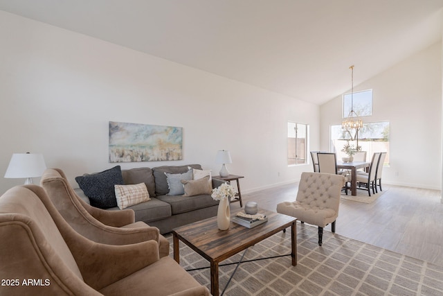 3837 E Windsong Dr, Phoenix, AZ 85048 - living area featuring a chandelier, baseboards, high vaulted ceiling, and light wood-style flooring
