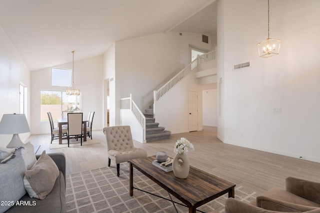 3837 E Windsong Dr, Phoenix, AZ 85048 - living room with a chandelier, stairway, high vaulted ceiling, and wood finished floors