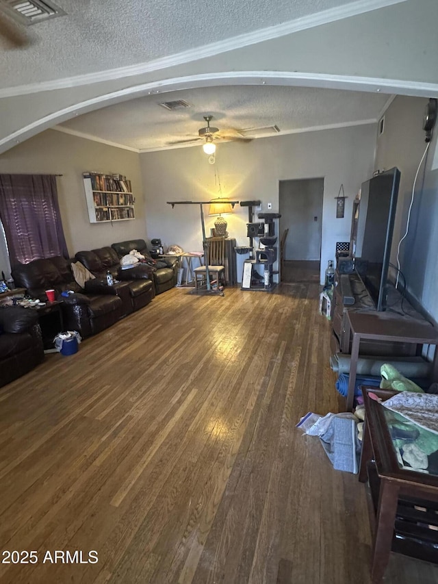 living room featuring a textured ceiling, ceiling fan, ornamental molding, and hardwood / wood-style flooring