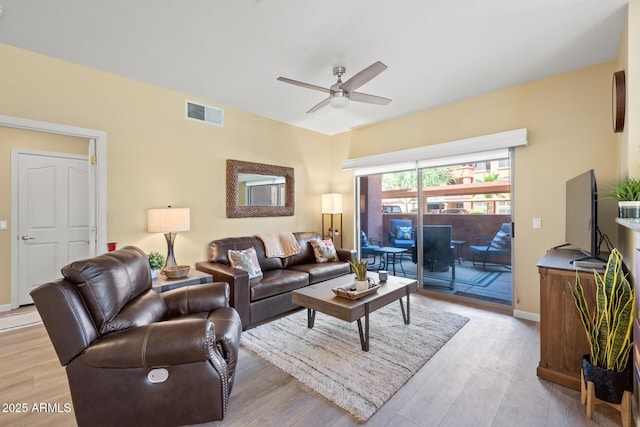 living area featuring baseboards, ceiling fan, light wood-style flooring, and visible vents