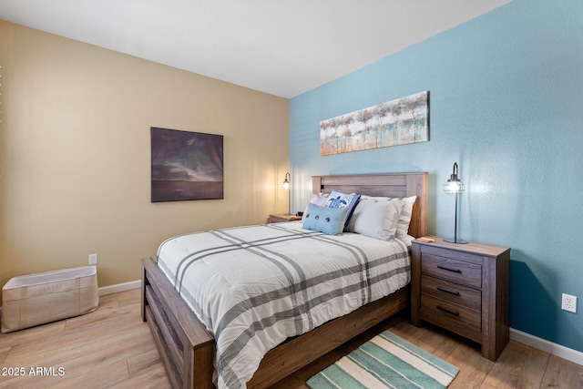 bedroom featuring baseboards and light wood-type flooring