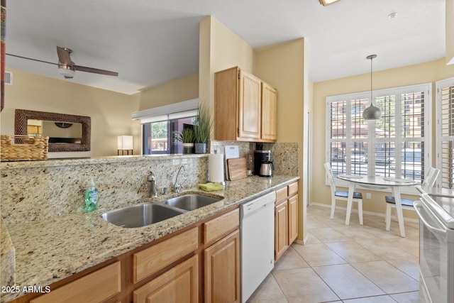 kitchen with a ceiling fan, tasteful backsplash, light stone countertops, a sink, and white appliances
